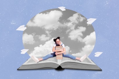 Girl sitting on open book hugging a stack of books