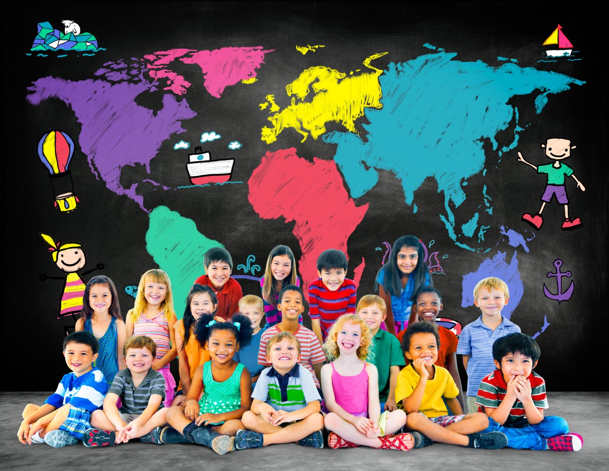 A group of children sit in front of a colorful map of the world.