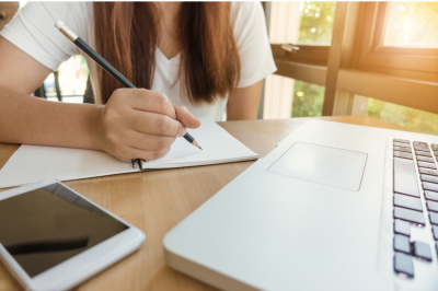 Girl doing homework at a laptop