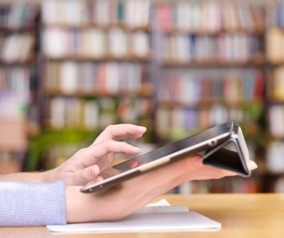 Sideview of a person holding their tablet