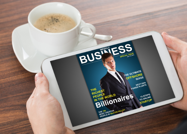 Image of hands holding a tablet with a digital magazine cover and a cup of coffee