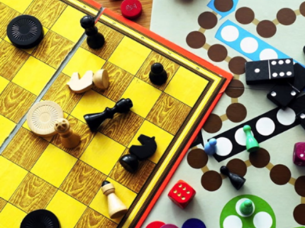 chess and go boards with red, yellow, blue, black and green game pieces