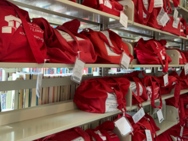 Image of shelves full of book club kit bags