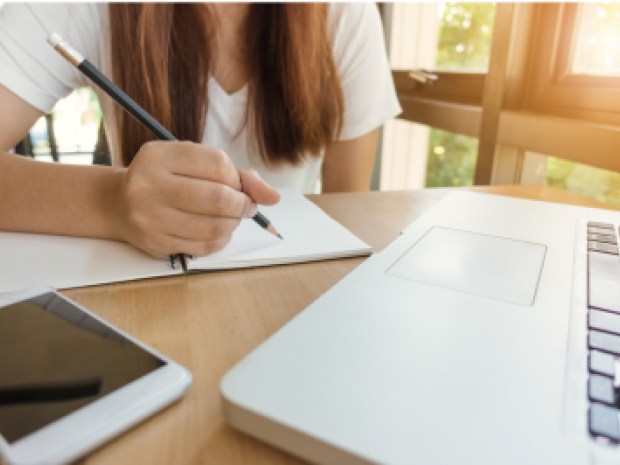 Girl doing homework at a laptop