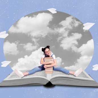 Girl sitting on open book hugging a stack of books